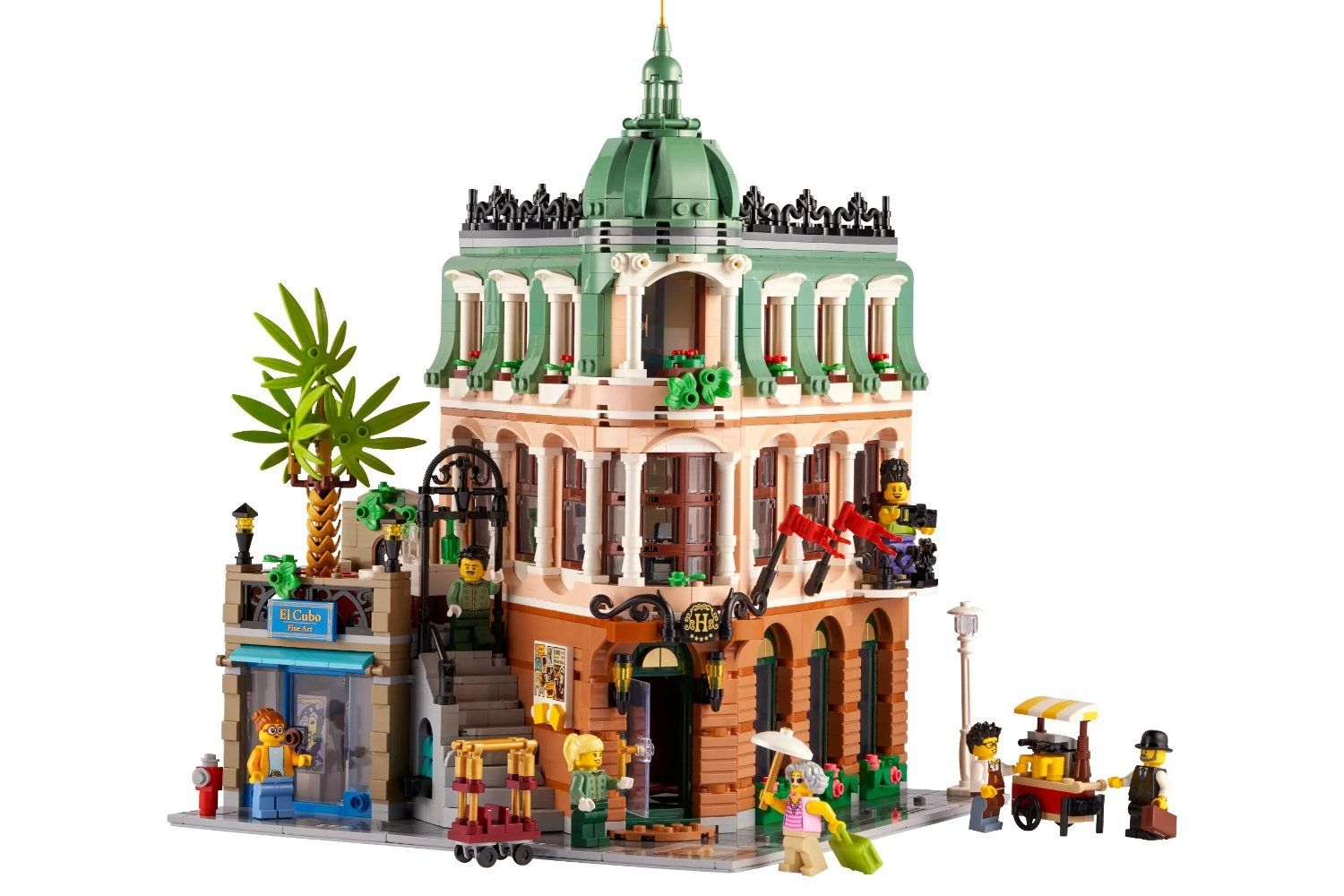 Adulto se diverte montando o novo Hotel Boutique de LEGO. Legenda da imagem. Reprodução: Gizmodo