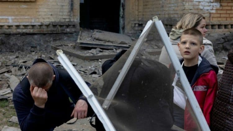 Moradora de Kiev busca abrigo com seus filhos durante ataque de mísseis russos.; Reprodução: Reuters