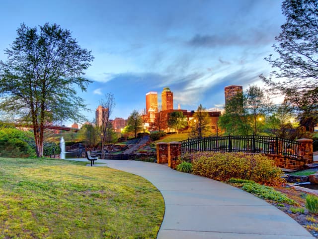 Cenário do skyline de Tulsa e um parque que simboliza a nova vida de um remote worker na cidade. Reprodução: Business Insider